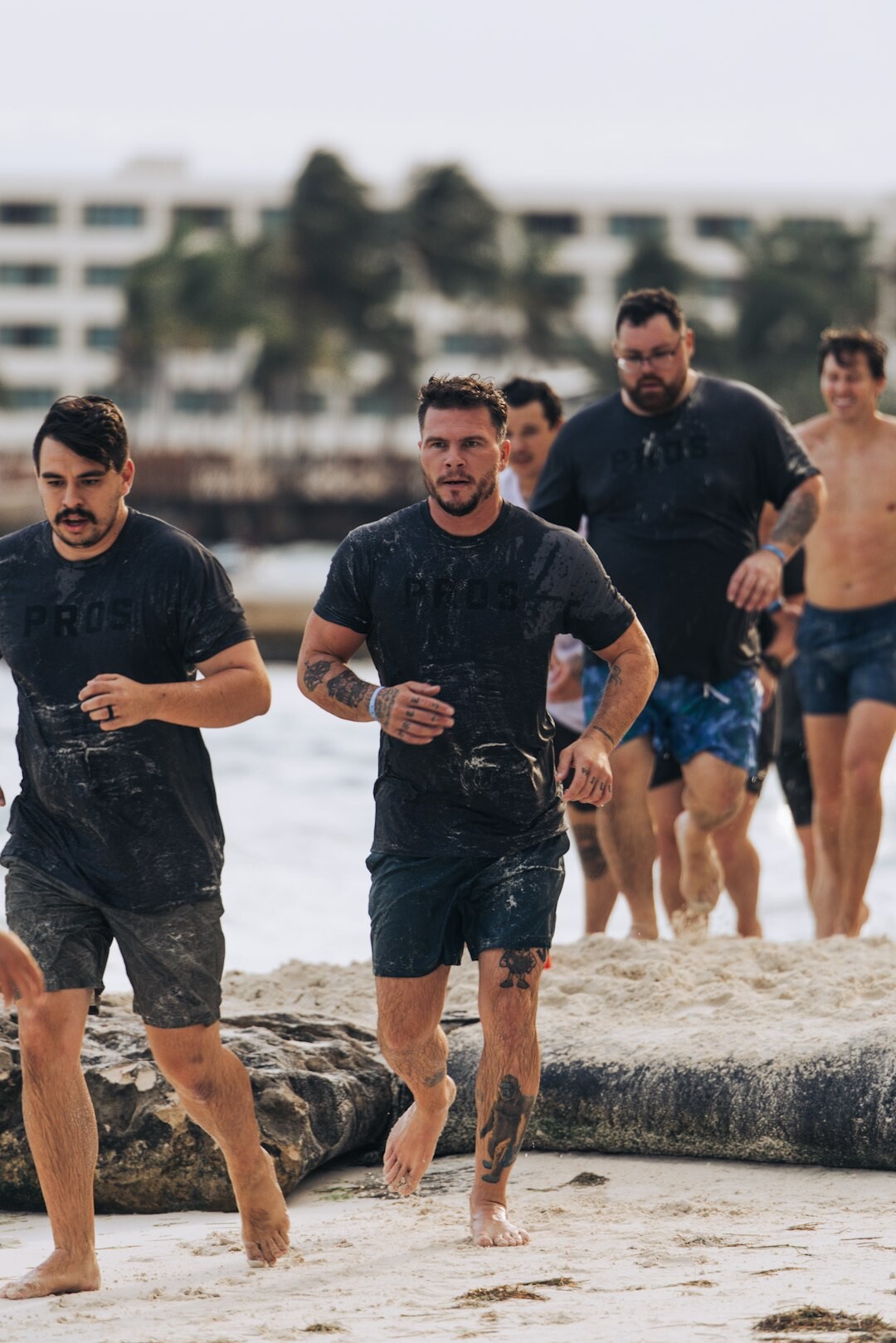 Group of colleagues completing an outdoor obstacle challenge together